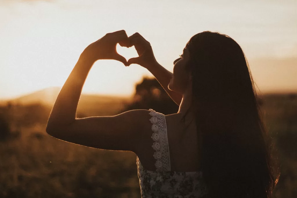 woman forming heart with her hands
