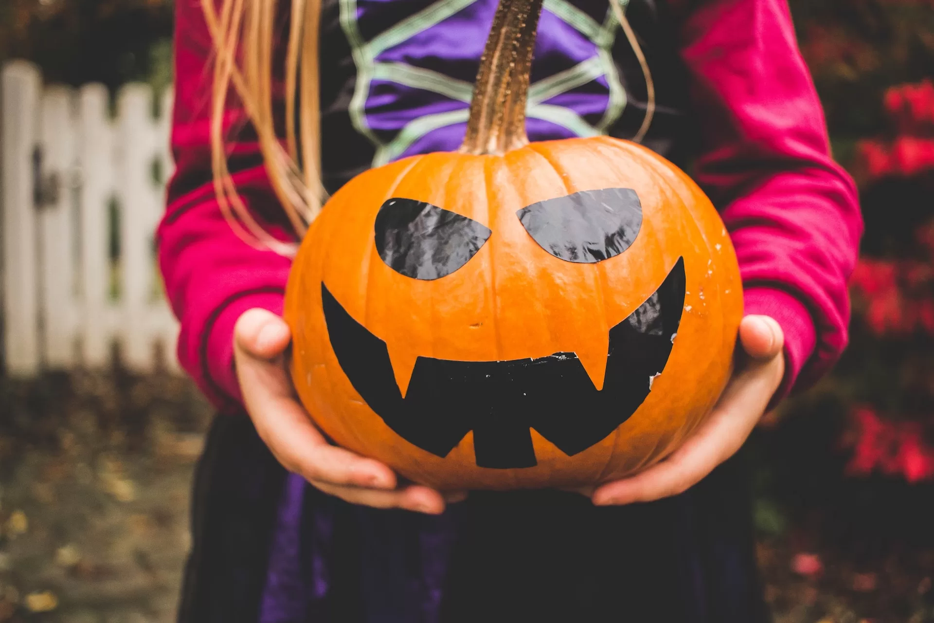 Girl holding Halloween pumpkin